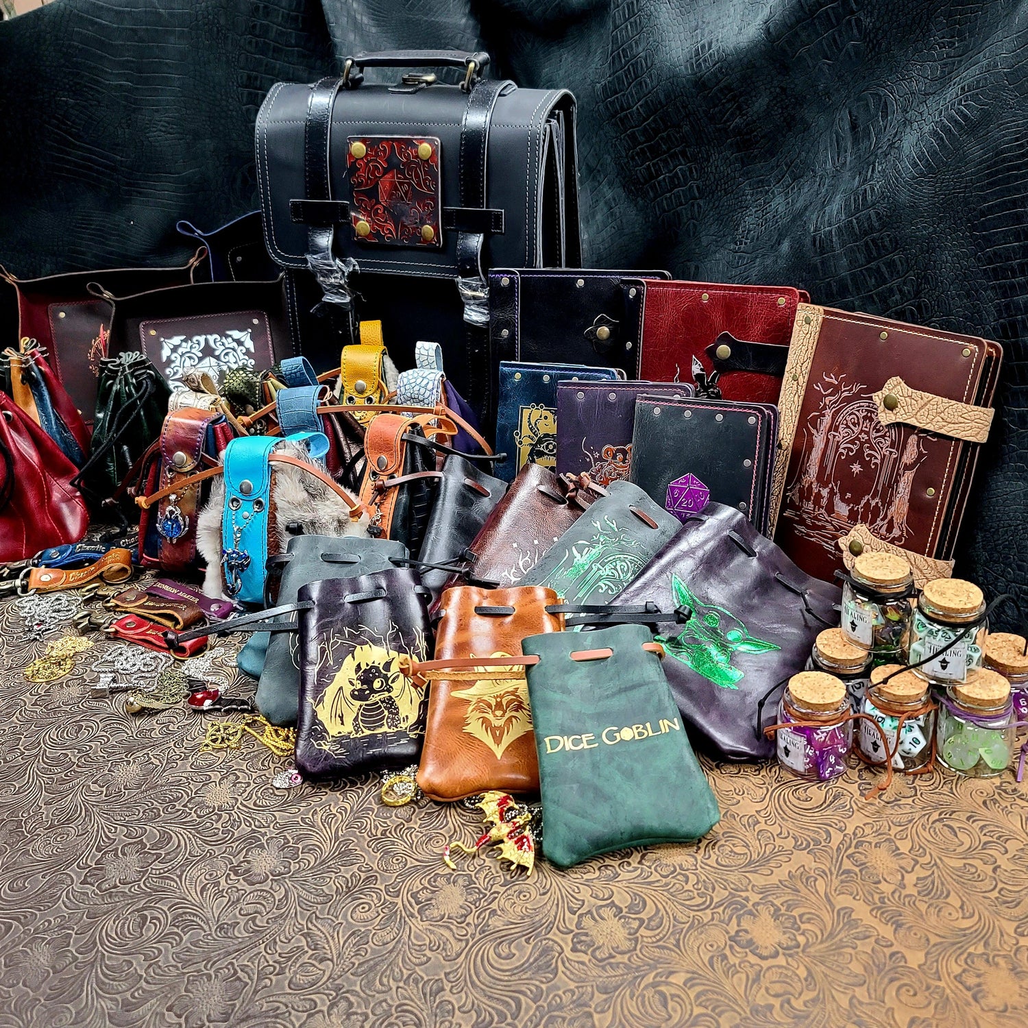 A retail starter box packed with assorted leather dice trays, journals, and tabletop gaming accessories.