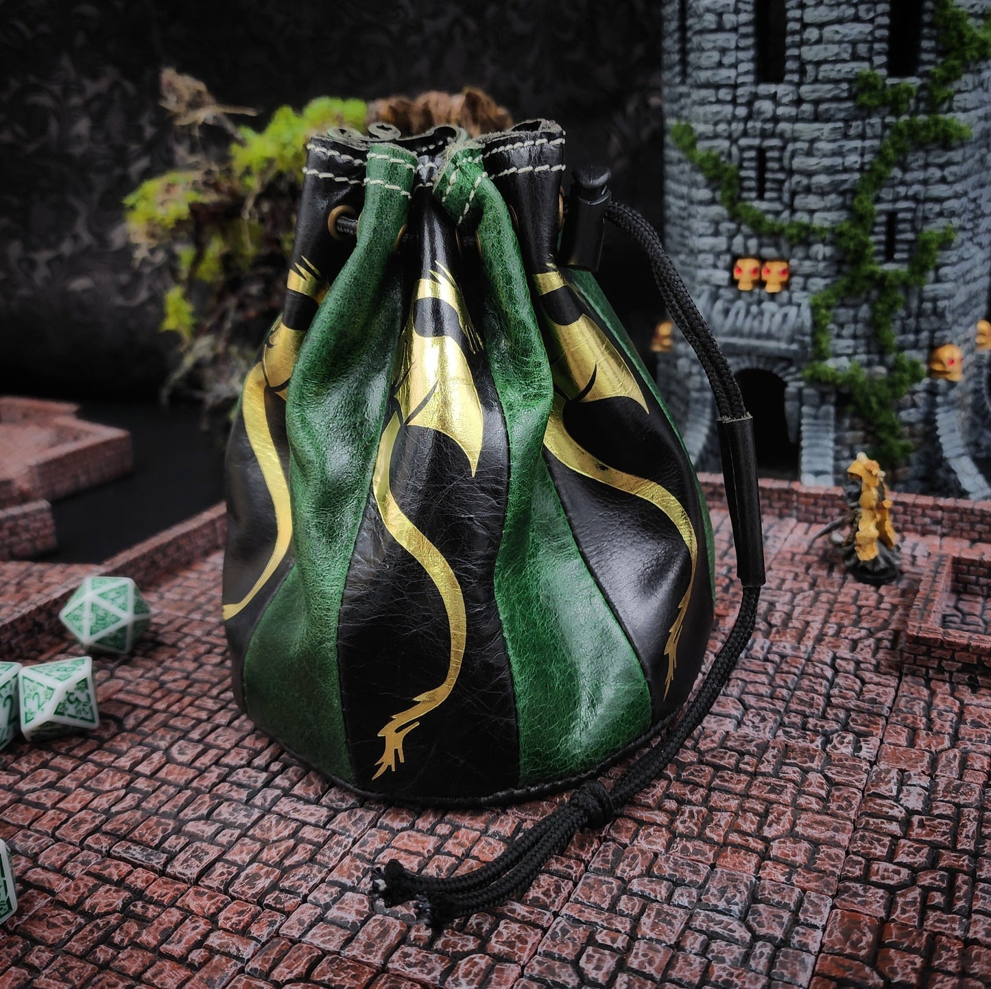 Handcrafted black and deep green buffalo hide standing round D&D dice bag with gilded Dragon design by Grimbeard Leather.