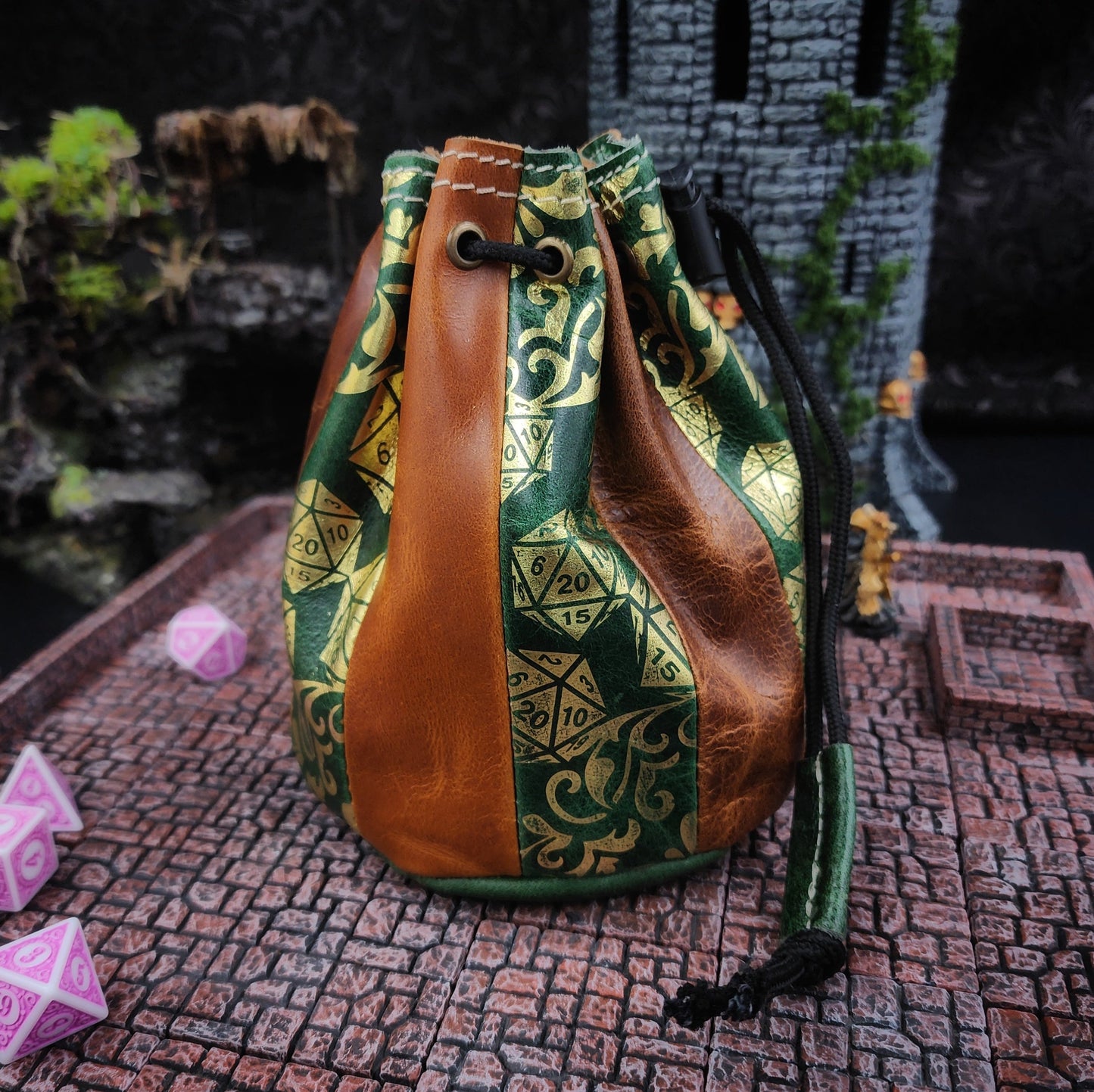 Handcrafted tan and deep green buffalo hide standing round D&D dice bag with gilded D20 pattern design by Grimbeard Leather.