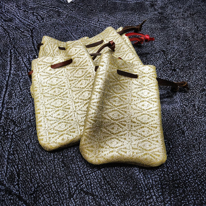 Handcrafted small leather dice bags in earthtones, blacks, and browns for D&D players and retail store counters.