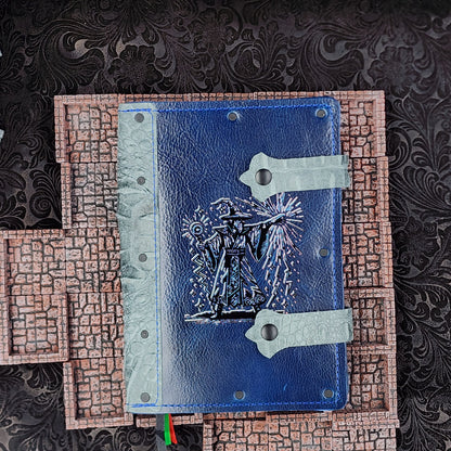Handcrafted 80s wizard themed A5 leather adventure journal for TTRPG notes, shown next to polyhedral RPG dice on a tabletop gaming setup.
