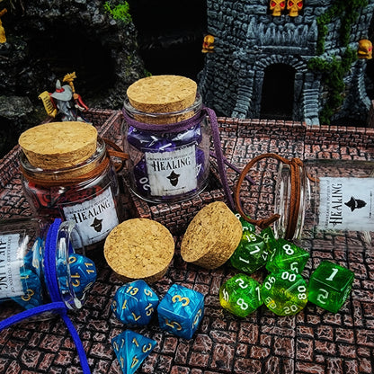Handmade leather strapped glass potion of healing dice vial containing a full 7-piece polyhedral RPG dice set for D&D tabletop gaming counter displays.